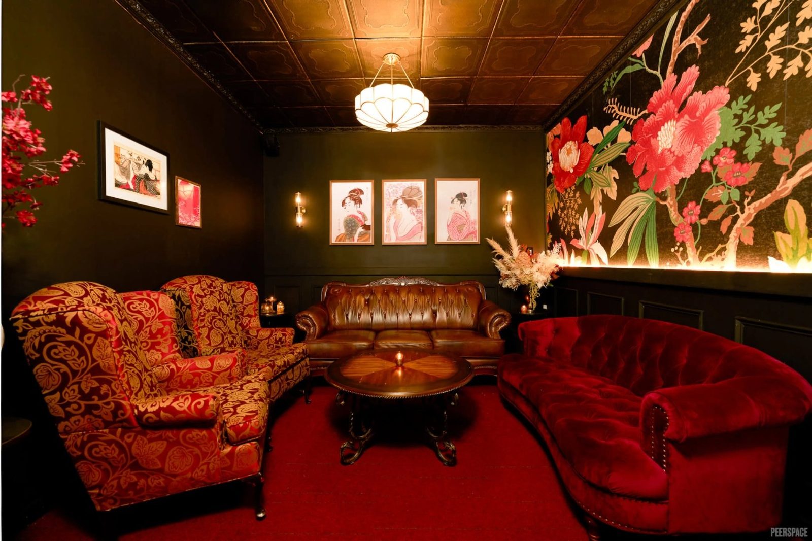 The Red Room — crimson velvet sofas, ukiyo-e prints, and dramatic floral wallpaper